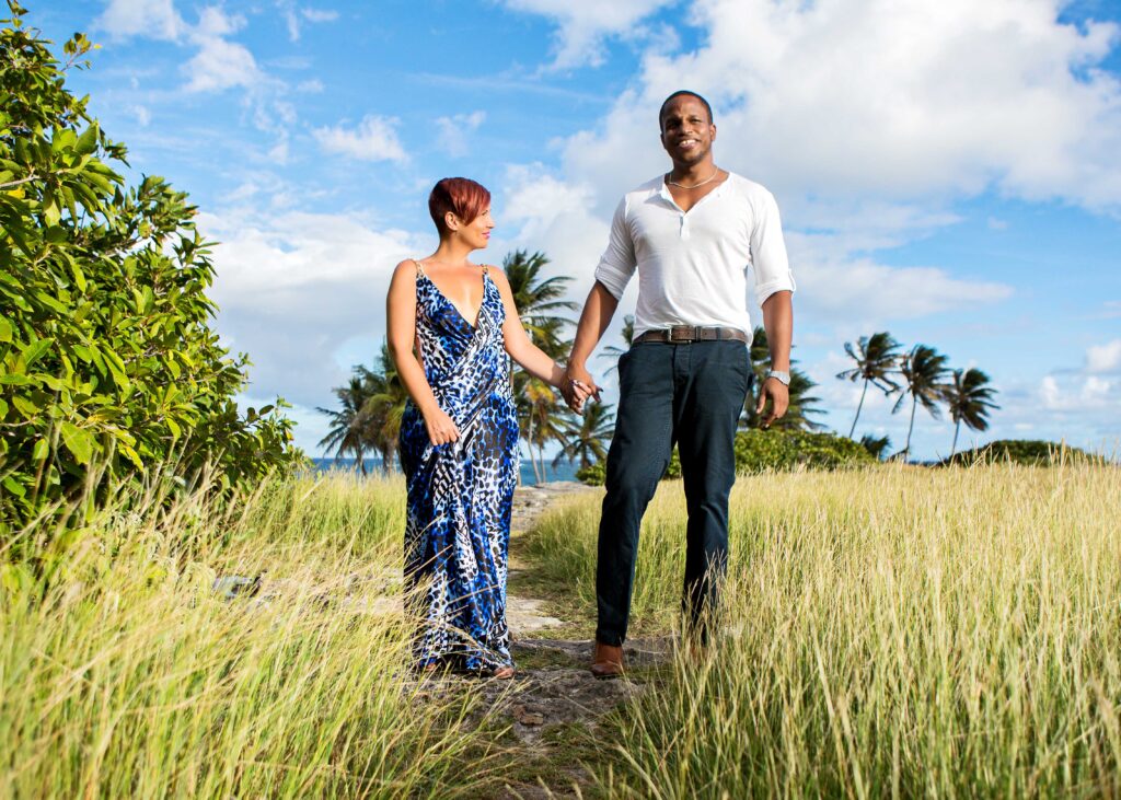 Couple holding hands on a coastal path in Barbados