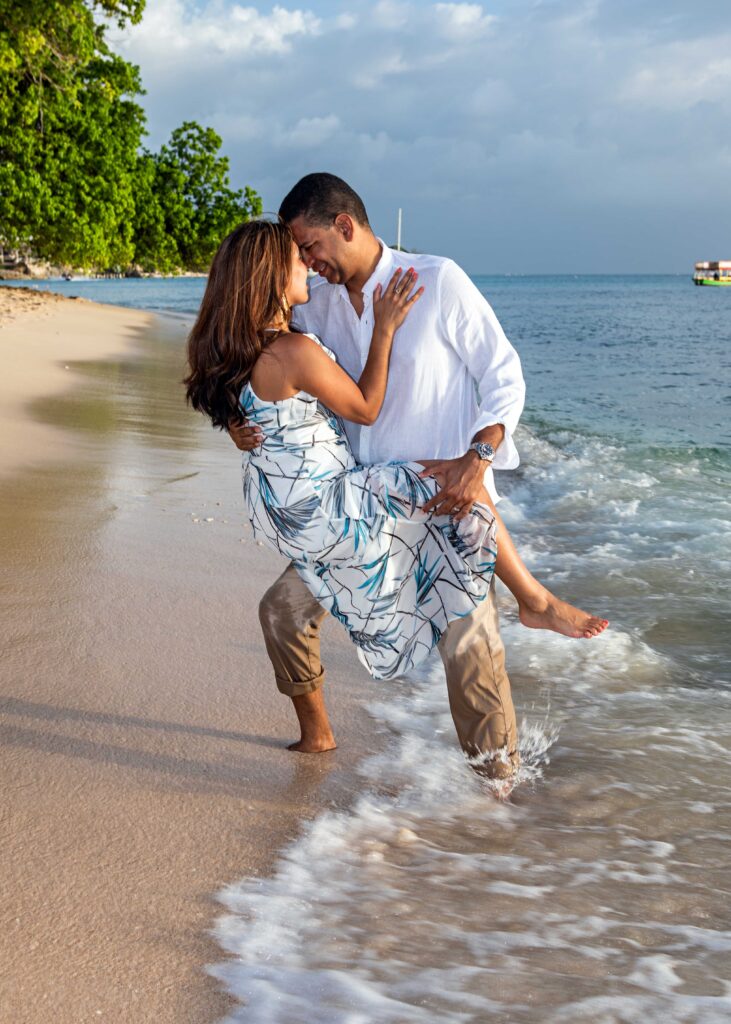 Couple embracing in the surf during a Barbados beach portrait session