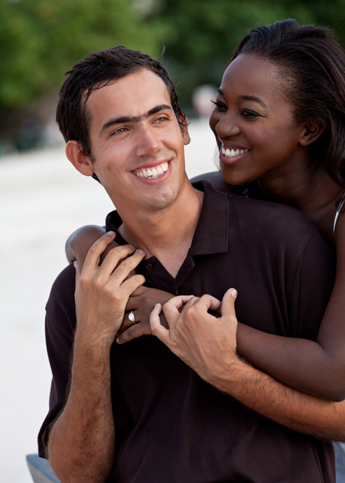 Smiling couple embracing during a Barbados beach portrait session