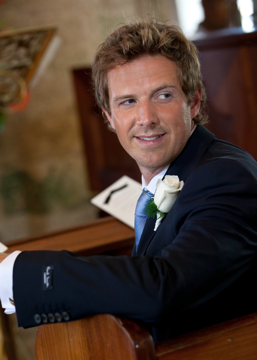 Groom seated in church before the wedding ceremony