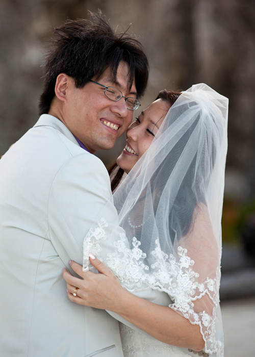 Smiling newlyweds embracing after their Barbados beach wedding