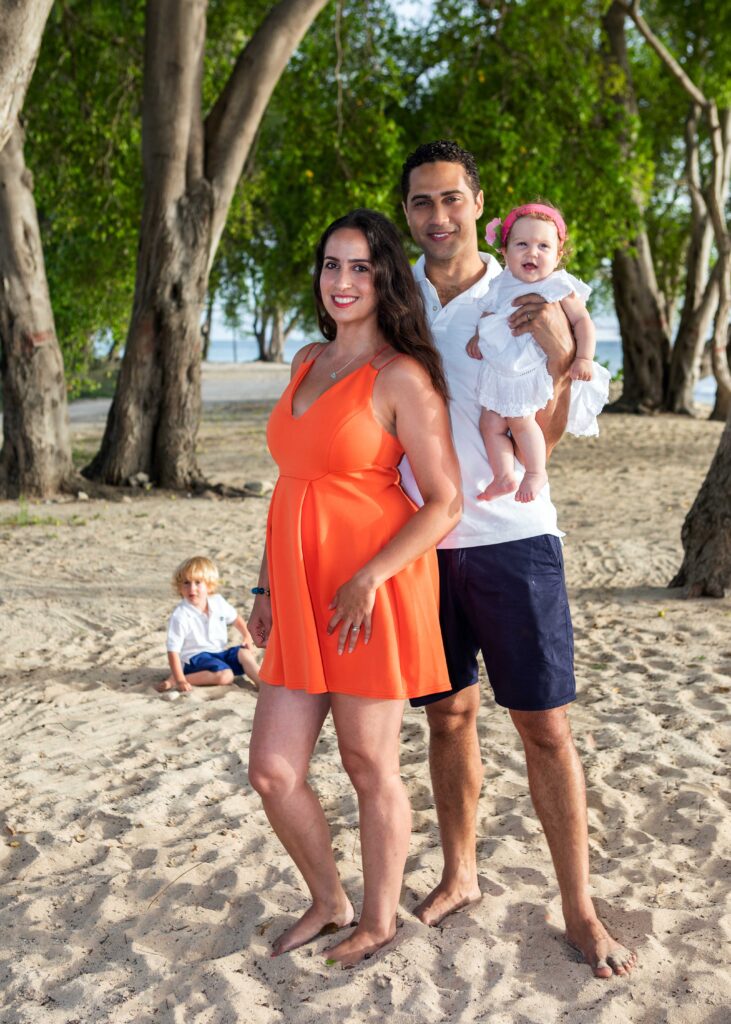 Family with young children during a Barbados beach portrait session