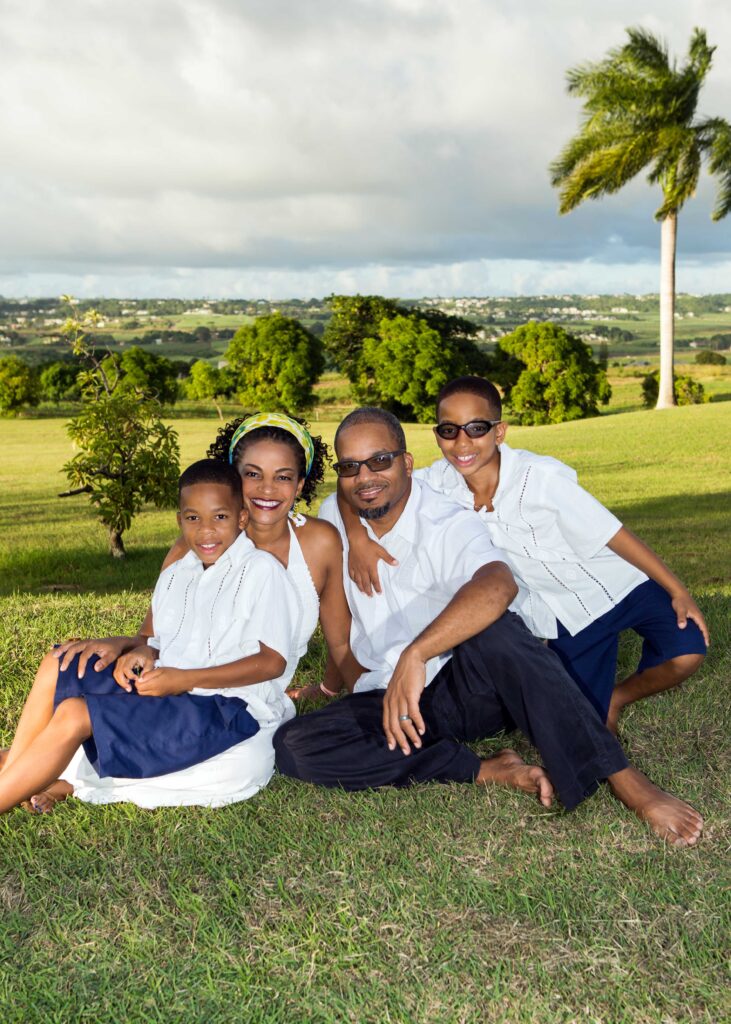 Family of four posing in the Barbados countryside