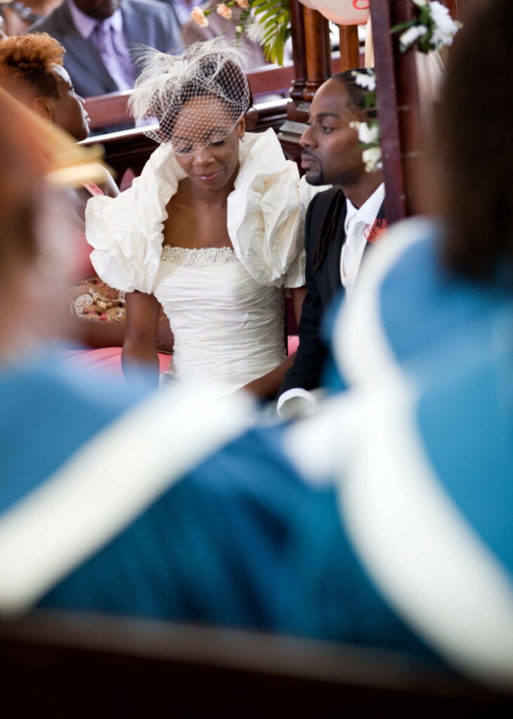 Bride and groom seated together during their church ceremony