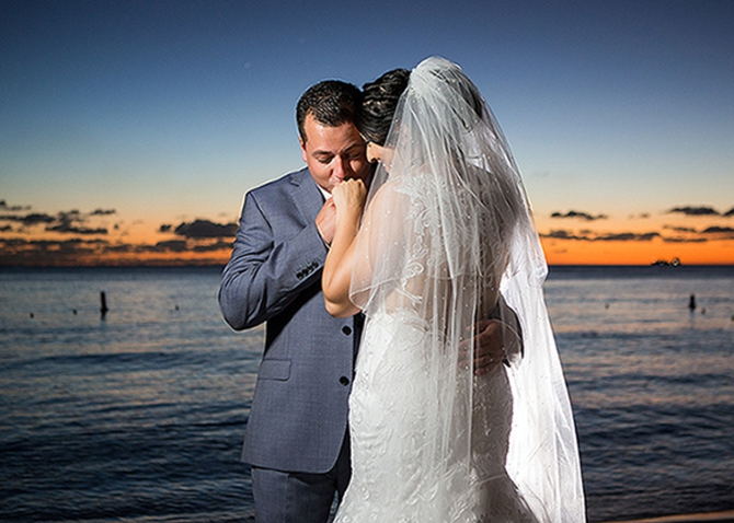 Bride and groom sharing a quiet moment at sunset in Barbados